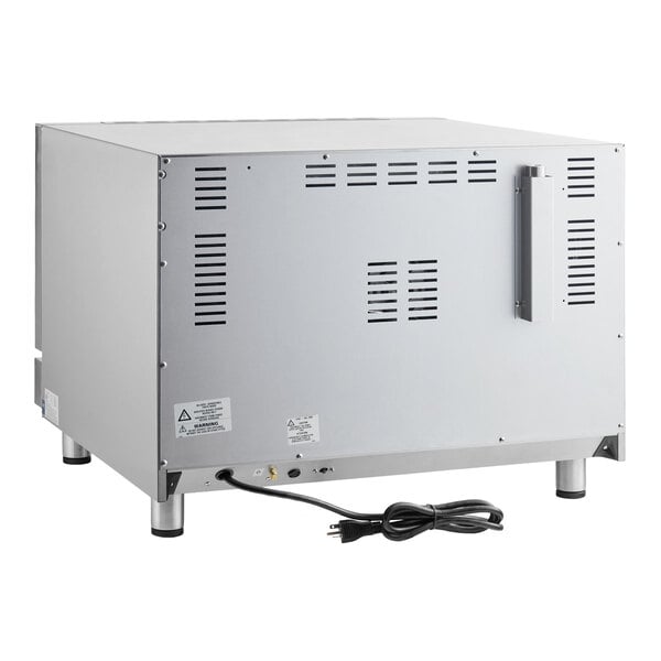 A metallic rectangular appliance with vented panels, four legs, a handle, and a power cord visible at the back.