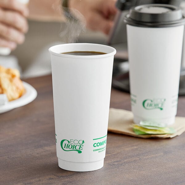 Two EcoChoice white paper hot cups filled with coffee on a table.