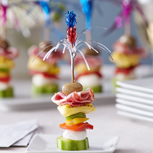 A plate of food with a Choice sparkler food pick in it.
