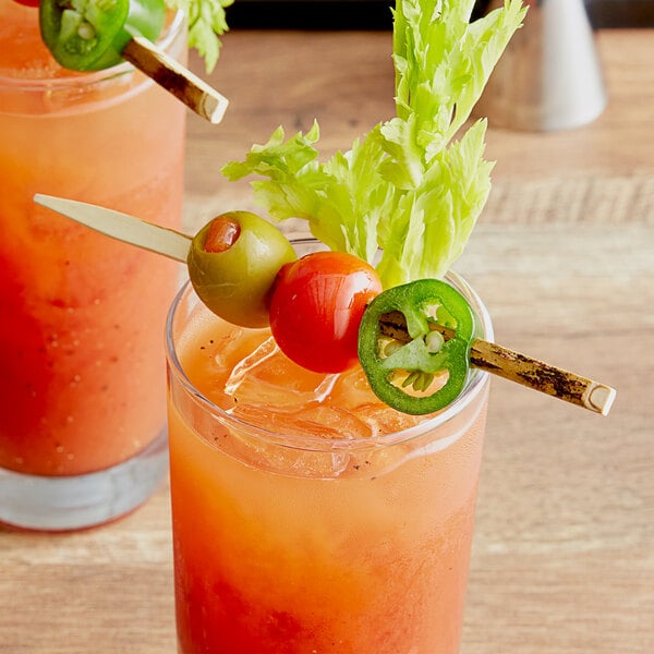 Two glasses of bloody drinks with TreeVive by EcoChoice Compostable Willow Flat Food Picks garnishes.