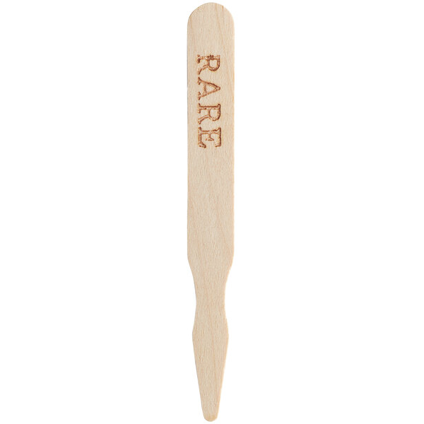 A wooden TreeVive by EcoChoice meat marker with the word "rare" engraved on it.