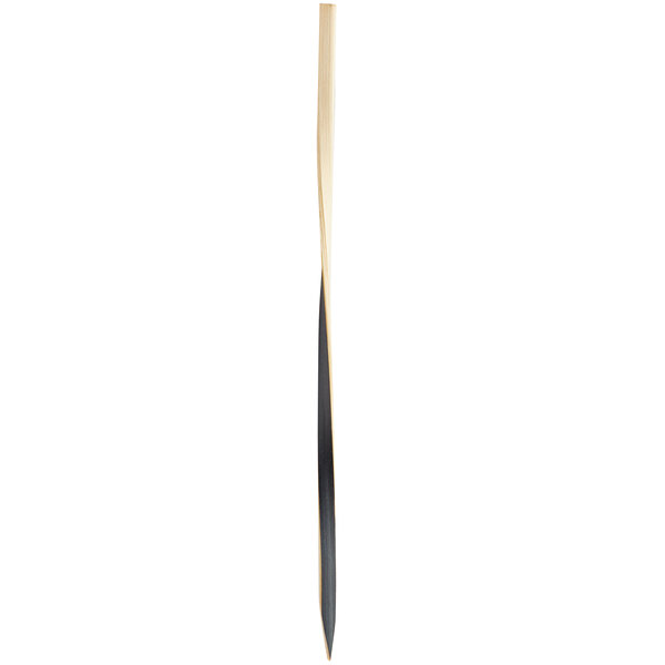 A long wooden skewer with a black twist.
