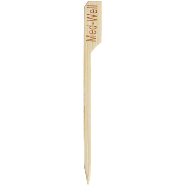 A wooden bamboo stick with "Medium Well" written on it.