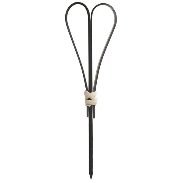 A black bamboo heart skewer on a table.