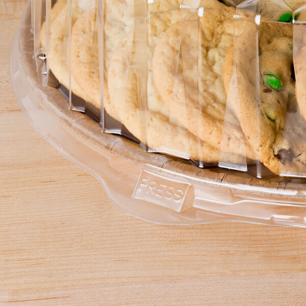 A clear plastic Solut catering tray lid on a plastic container of cookies.