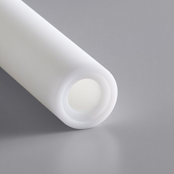 A white plastic roller tube with a small hole in it.