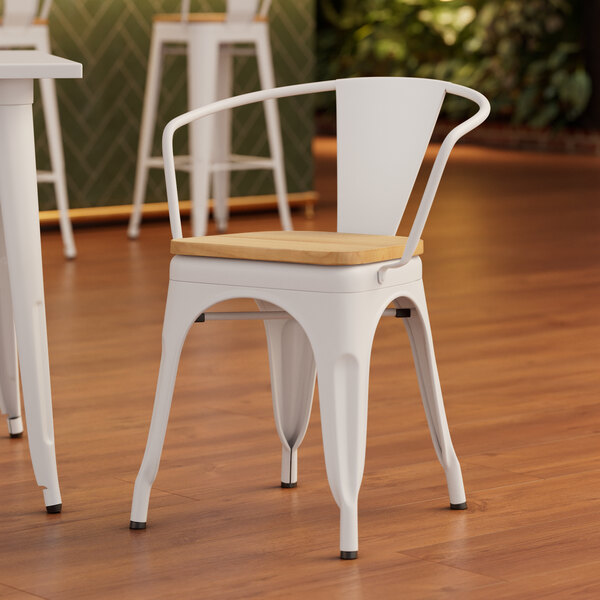 A Lancaster Table & Seating white arm chair with a natural wood seat.