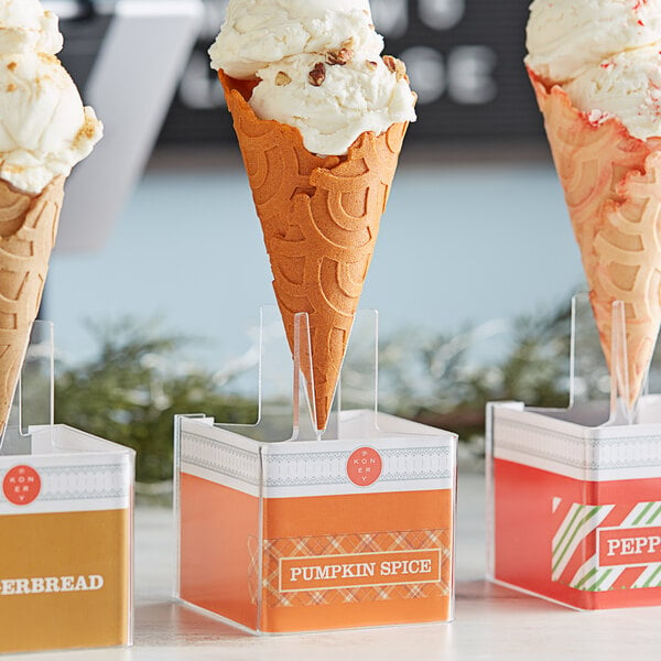 A row of pumpkin spice waffle ice cream cones in a box.