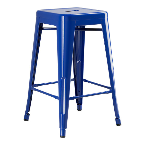 A blue Lancaster Table & Seating metal backless counter height stool with legs.