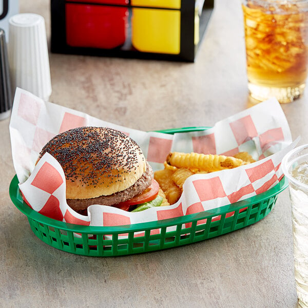 A basket with a hamburger and fries lined with a red check paper.