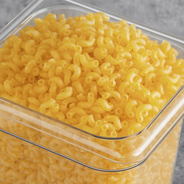 A case of Barilla gluten-free elbow pasta on a table.