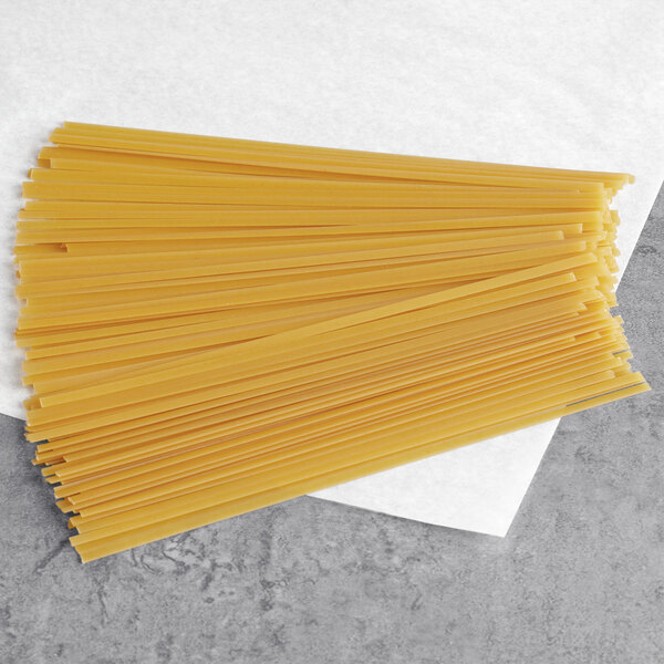 A pile of Barilla Fettuccine pasta on a white napkin.
