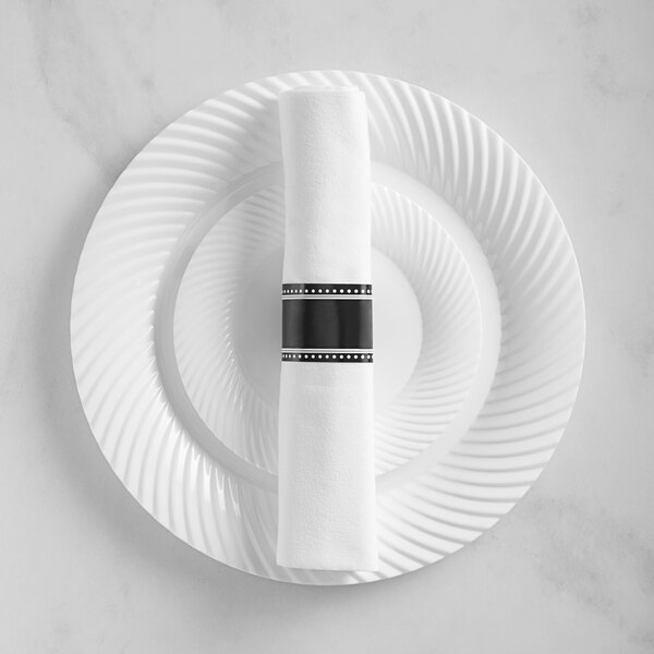 A white plate with a curved edge and a black band on it.