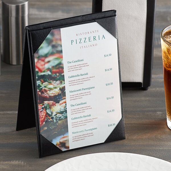 A black H. Risch table tent on a table with a menu showing pizza.