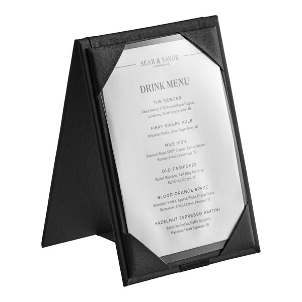 A black H. Risch, Inc. table tent with a white menu on it.