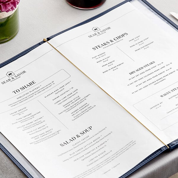 A menu with a H. Risch, Inc. gold elastic band on a table.