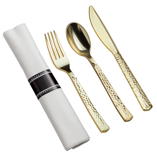 A Visions white plastic dinnerware set with hammered flatware, including a spoon and fork.