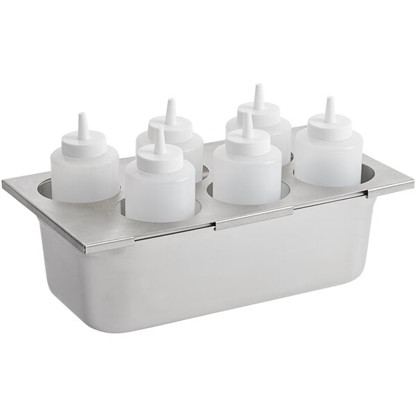 A stainless steel tray with six white plastic squeeze bottles with white caps.