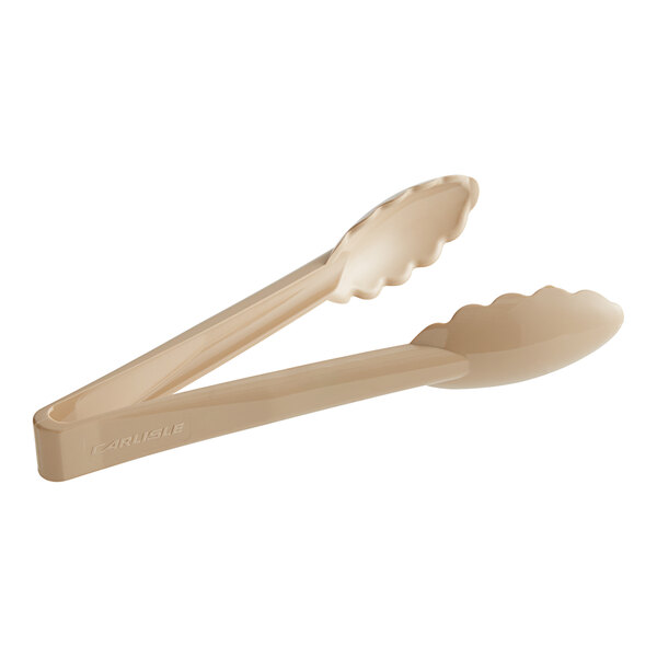 A pair of Carlisle beige plastic utility tongs with spoon-shaped ends.