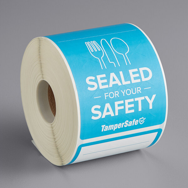 A roll of TamperSafe blue paper labels with the text "Sealed For Your Safety" on them.