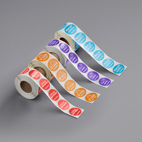 A roll of orange TamperSafe drink labels with text on a white background.