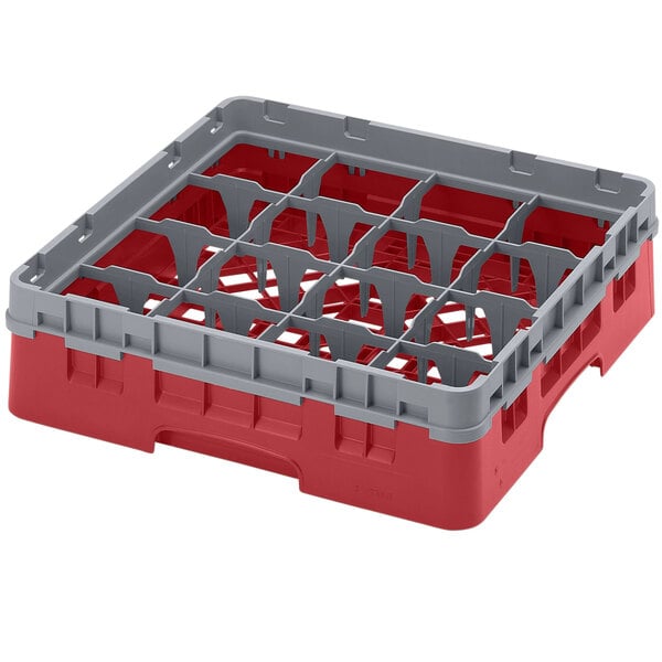 A red and grey plastic Cambro glass rack with 16 six compartments.