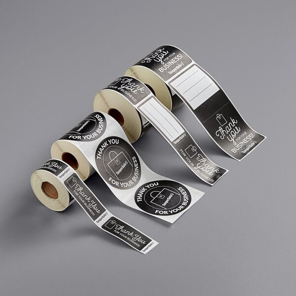 A roll of black paper TamperSafe labels with the words "Thank You For Your Business" on it.