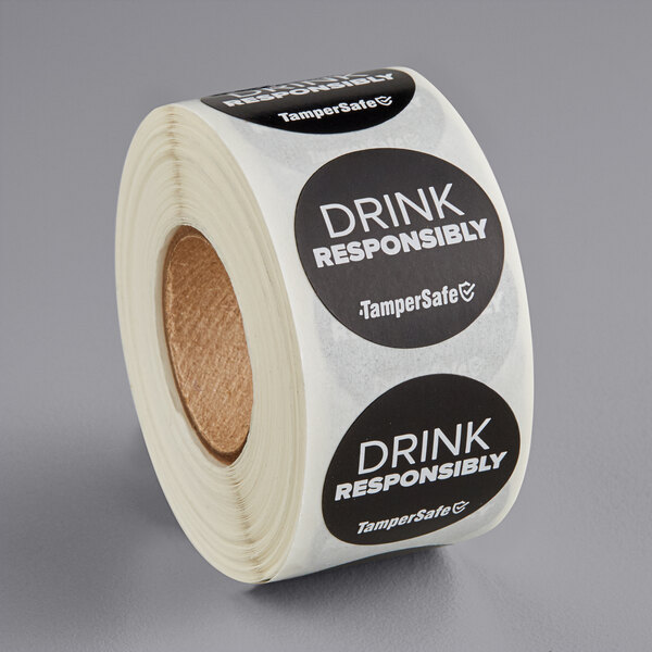 A roll of TamperSafe drink responsibly labels with black and white text.
