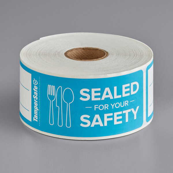 A roll of TamperSafe blue paper labels with the text "Sealed For Your Safety" on them.