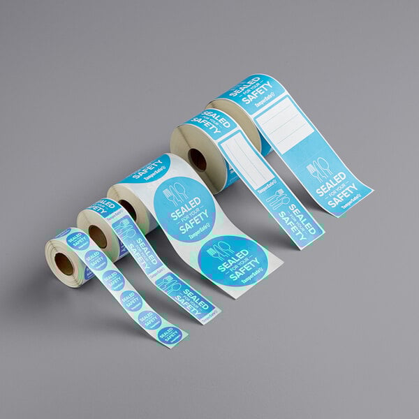 A roll of white TamperSafe blue paper labels with the words "Sealed For Your Safety"