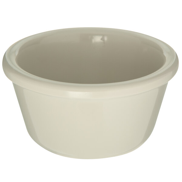 A Carlisle white melamine ramekin with a white rim.
