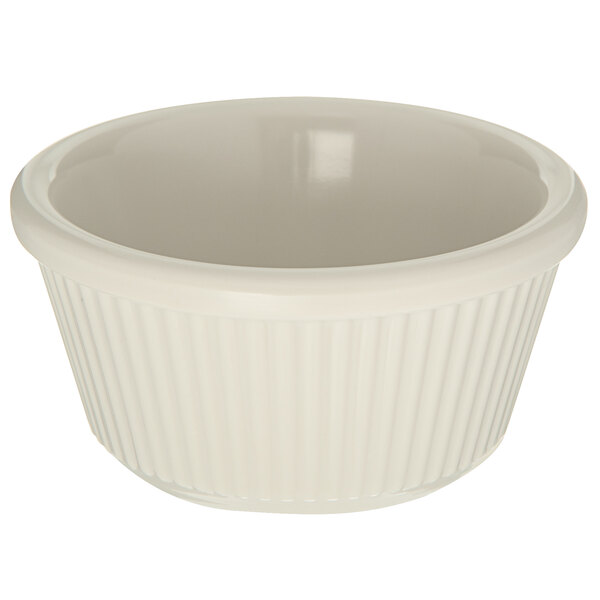 A Carlisle bone white fluted melamine ramekin with a white rim.