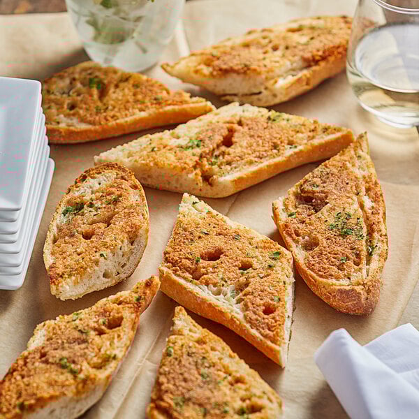 A plate of toasted bread with green sprinkles on it.