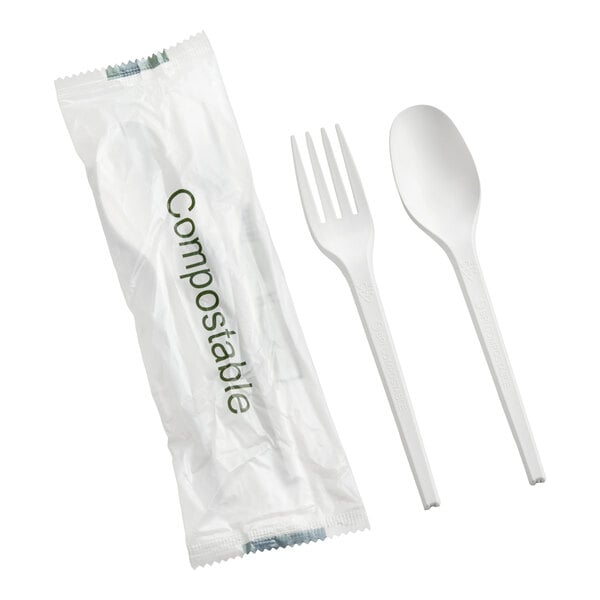A set of white compostable heavy weight plastic spoon and fork with individual wrapping.