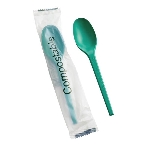 A green compostable heavy weight spoon, with one spoon individually wrapped in plastic packaging labeled 'Compostable.'