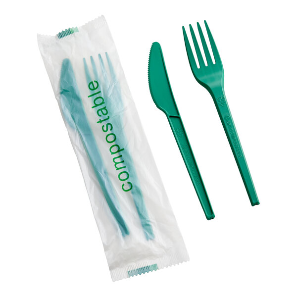 A set of green compostable heavy weight knife and fork, individually wrapped in plastic.