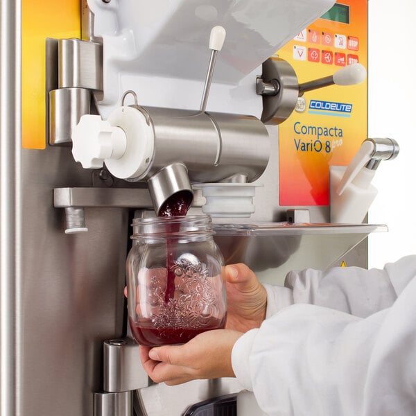 Person dispensing frozen product out of a batch freezer
