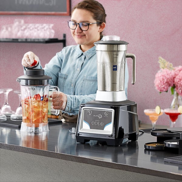 A woman using an AvaMix commercial blender to make a smoothie.