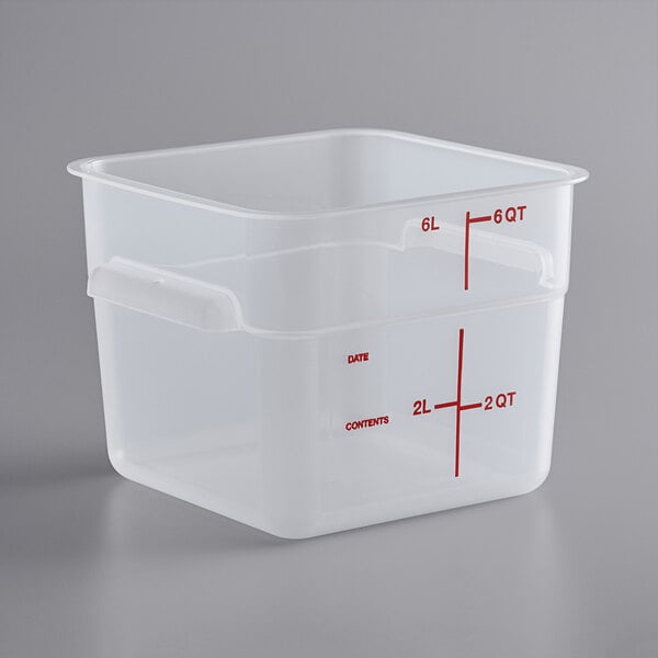 A translucent square plastic food storage container with red measurements on it.