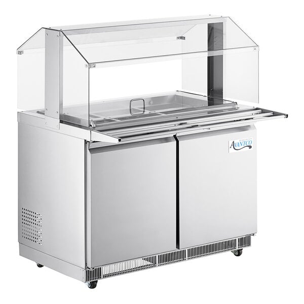An Avantco stainless steel refrigerated salad bar on a counter with a sneeze guard.