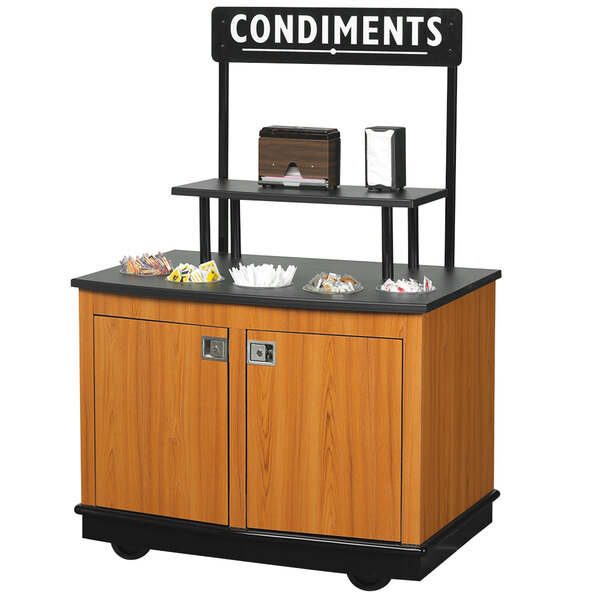 A Vollrath condiment cart with a sign and shelf.