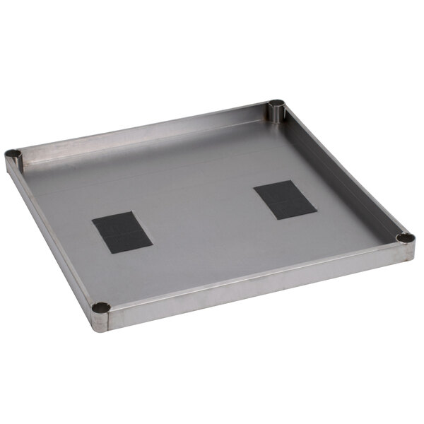 A stainless steel shelf with two holes in it.