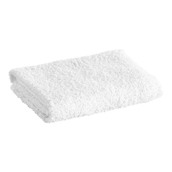 A folded white textured towel is shown against a plain background.