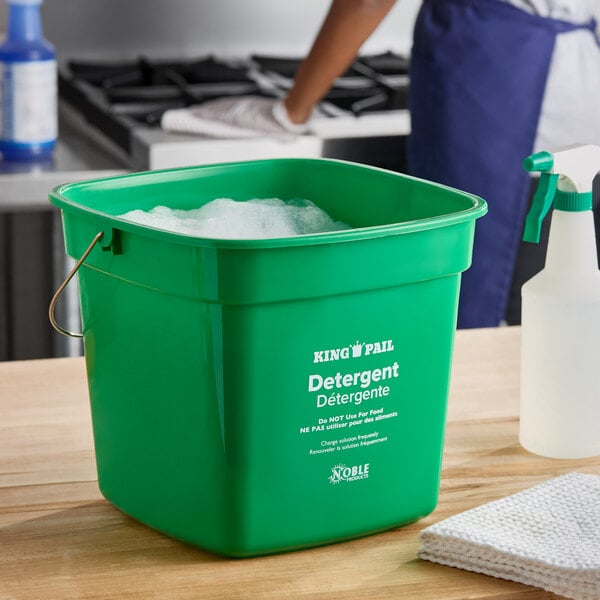 A green Noble King-Pail 10 quart detergent pail filled with soapy water.