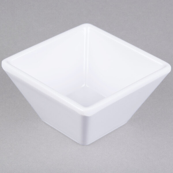 An American Metalcraft white melamine square sauce cup with a black stripe on it.