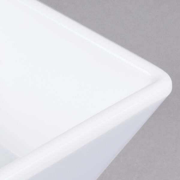 A close up of an American Metalcraft white melamine square sauce cup.