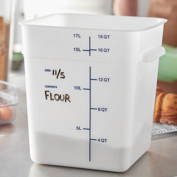 A close-up of a white Carlisle square food storage container with black writing on it.