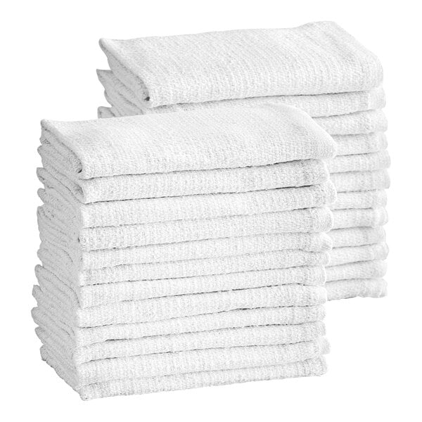 Two stacks of neatly folded white textured towels are shown against a plain background.