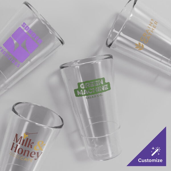 A group of clear Acopa Endure stackable plastic glasses with a purple logo.