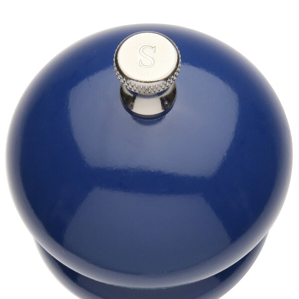 A cobalt blue ceramic salt mill with a silver knob.